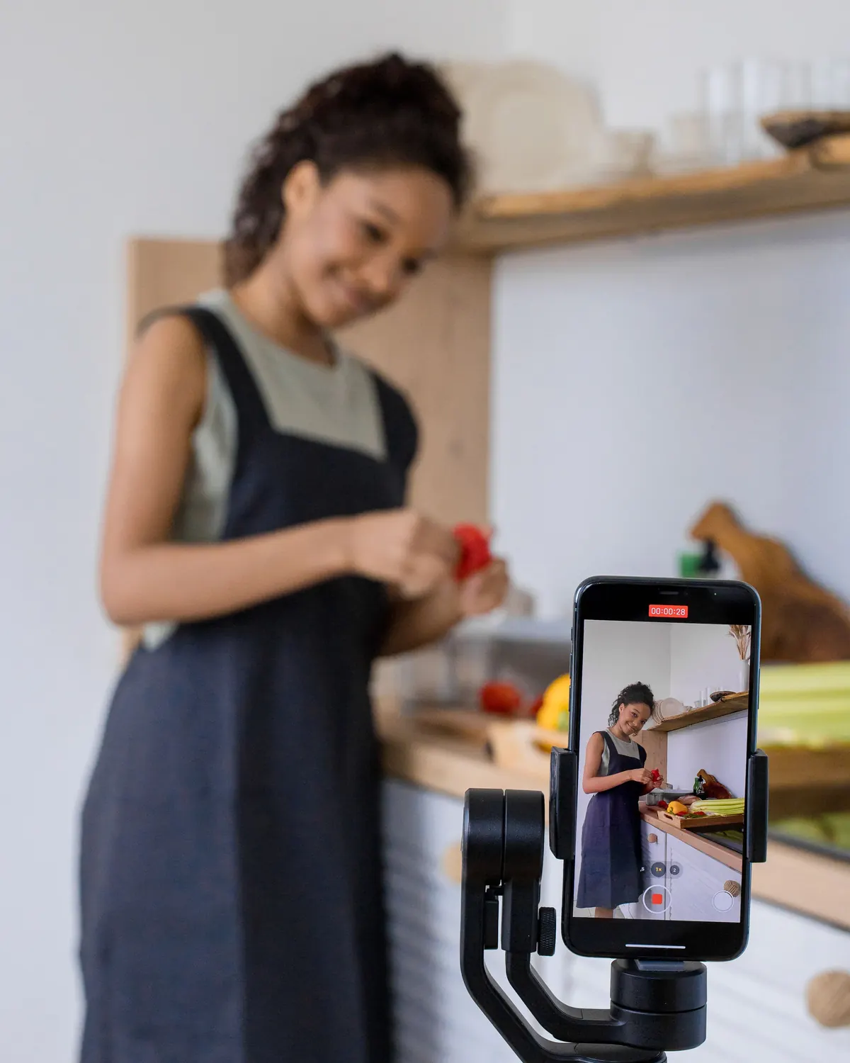 A creator filming a video on her phone